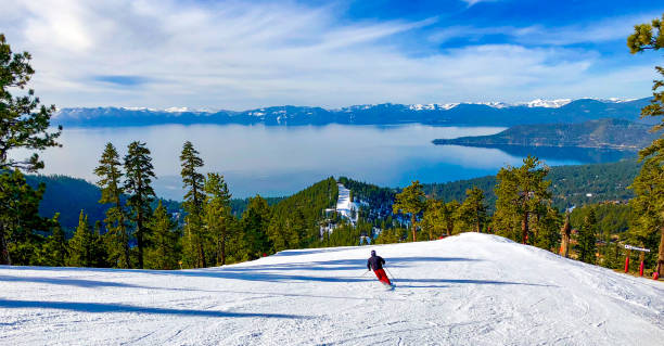 Skier skiing down a run with a view of Lake Tahoe